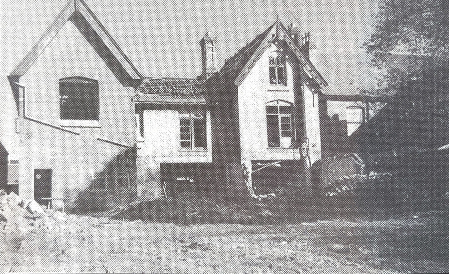 A partially constructed or renovated building with a mix of architectural styles, featuring exposed walls and a construction site in the foreground.