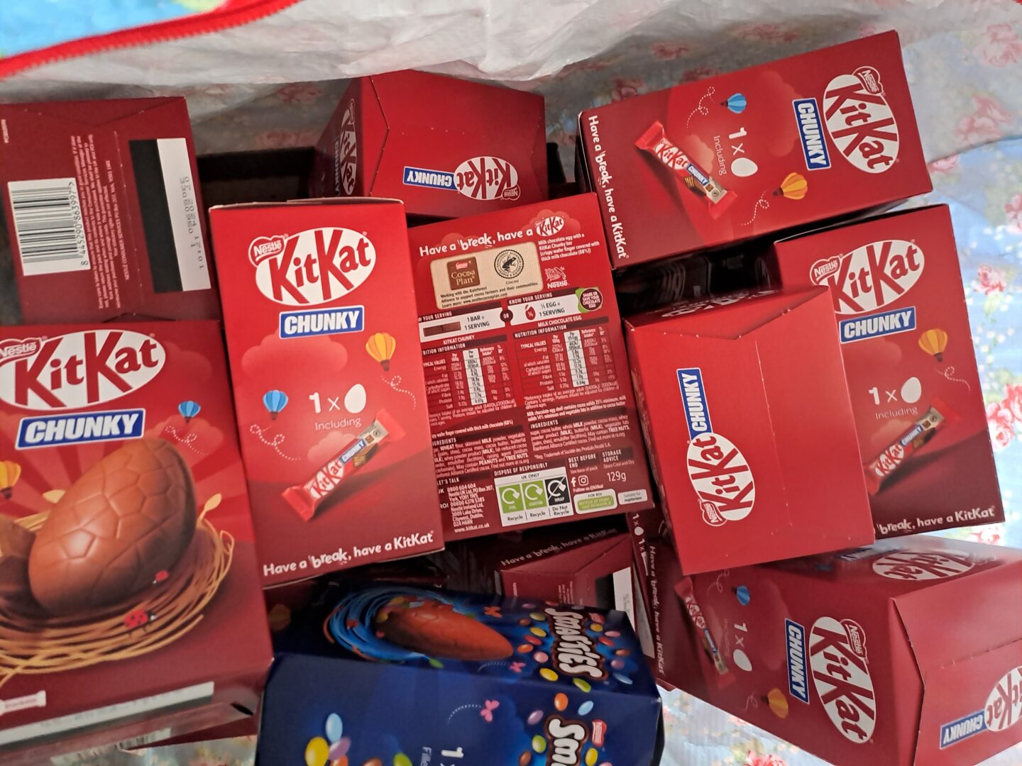 Boxes of Easter eggs - Kit Kat Chunky and Smarties - are packed into a large bag.